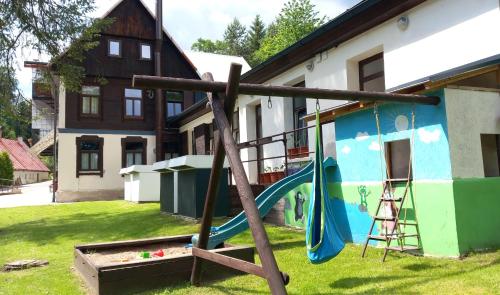 a playground in the yard of a house at Penzion Betlém in Janske Lazne