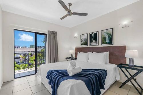 a bedroom with a large bed and a balcony at Tropic Nest - A Relaxed Resort Escape for Couples in Cairns