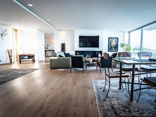 a living room with a table and chairs and a couch at Villa AzaiTu Suites in Porto-Vecchio