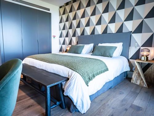 a bedroom with a king sized bed and a wall mural at Villa AzaiTu Suites in Porto-Vecchio