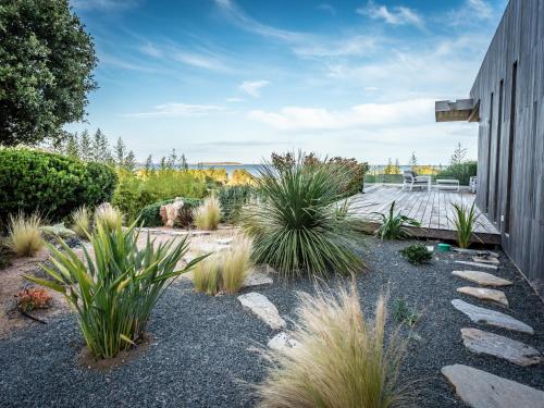 a garden with plants on the side of a building at Villa AzaiTu Suites in Porto-Vecchio