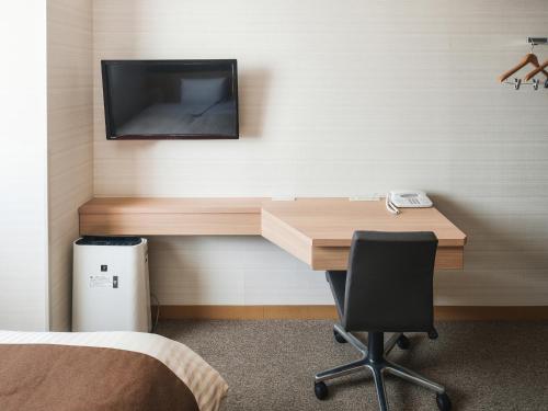 Vessel Inn Yachiyo Katsudai Stationにあるテレビまたはエンターテインメントセンター