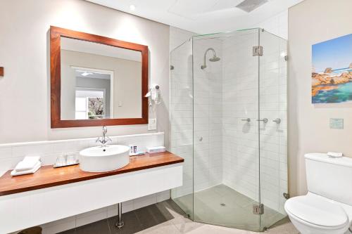 a bathroom with a sink and a shower at Caves House Hotel & Apartments Yallingup in Yallingup