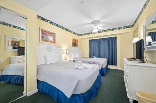 a hotel room with two beds with teddy bears on them at Luxury 11th Floor 1 BR Condo Direct Oceanfront Wyndham Ocean Walk Resort Daytona Beach | 1105 in Daytona Beach