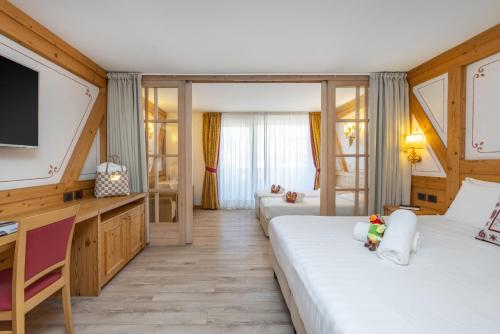 Postel nebo postele na pokoji v ubytování Piz Galin Grand Hotel Family & Wellness
