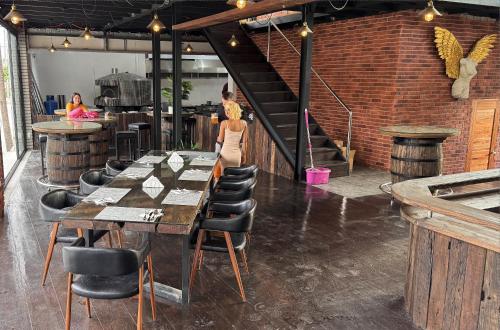 a restaurant with a long table and chairs and a staircase at Bavarian Guest House in Angeles
