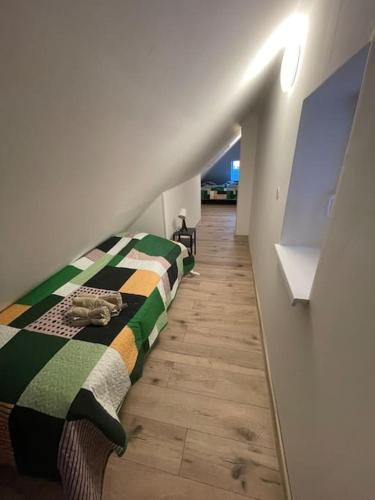 a bedroom with a bed with a green and colorful blanket at Francis Apartment II - Spa Center Karlovy Vary in Karlovy Vary