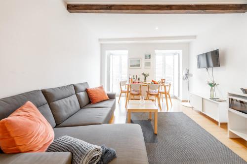 a living room with a couch and a table at Casas do Olival Apartments in Lisbon