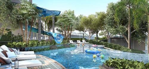 a swimming pool with a slide in a resort at Sea View Spacious Condo At Pattaya in Pattaya Central