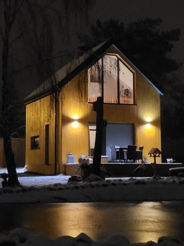 a house in the snow at night at Leśna Stodoła in Lubień Kujawski