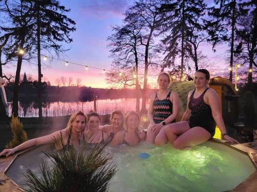 a group of women sitting in a hot tub at Leśna Stodoła in Lubień Kujawski