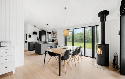 a kitchen and dining room with a wood stove at 3 Bedroom Nice Home In Store Fuglede in Store Fuglede