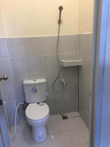 a small bathroom with a toilet and a shower at Baie Benie Beach Resort in Balibago