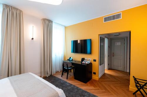 a hotel room with a bed and a desk in it at Ecletico Villa in Bucharest