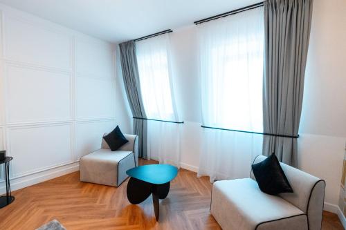 a living room with two chairs and a table at Ecletico Villa in Bucharest