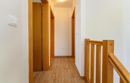a hallway with a stairway with a wooden stair case at Stunning Apartment In Rtina With Wifi in Rtina