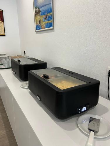 two microwaves sitting on top of a counter at Gorgona Hotel in Amoudara Herakliou