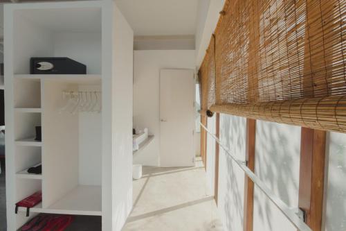 a room with a hallway with white walls and a door at Villa Amma Erna - Galle in Galle