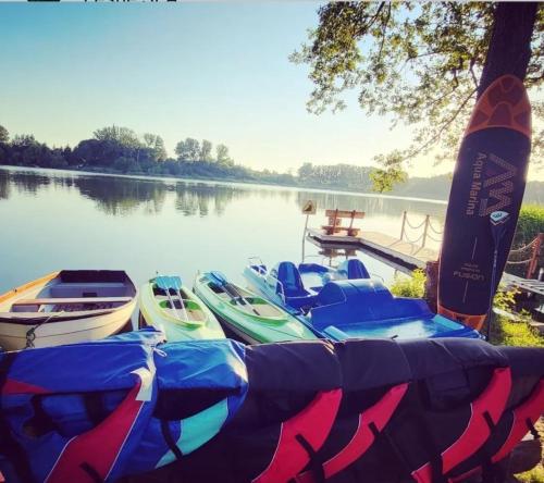 a group of boats parked next to a lake at Leśna Stodoła in Lubień Kujawski