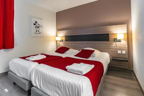 a bedroom with a large bed with red and white sheets at Hotel Argos in Vendenheim