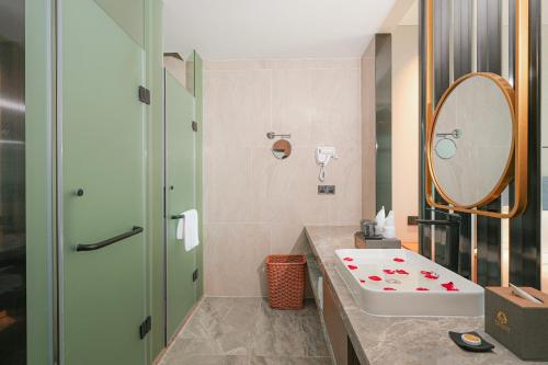 a bathroom with a sink and a mirror at DongHu Resort Hotel in Sihanoukville