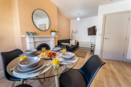 a dining room with a table with a plate of food at Terracotta Apartment, free WiFi & parking, coastal location in New Brighton