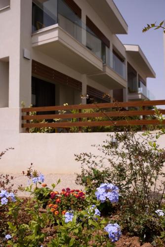 a house with flowers in front of it at Falena Luxury Rooms in Kalyves Poligirou