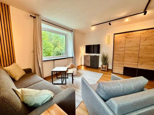 a living room with a couch and a window at Apartment Christl in Sankt Jakob in Defereggen