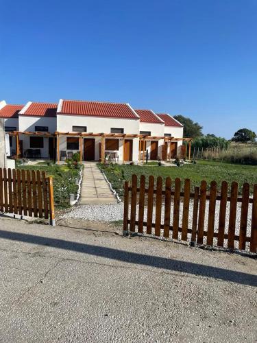 a house with a fence in front of it at VICTORY SUITES in Samothráki