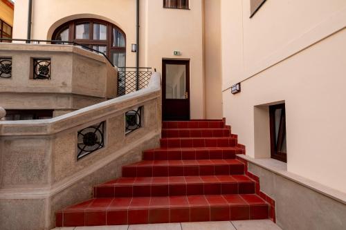 a staircase in a building with a red stair case at Ecletico Villa in Bucharest
