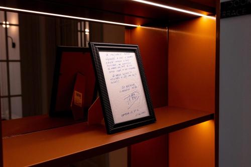 a framed sign on a shelf in a room at Ecletico Villa in Bucharest