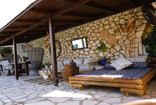 a room with a bed and a stone wall at Luxury Villa Athina in Nikiana