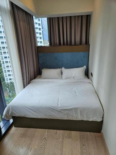 a bed in a bedroom with a large window at Star Residence Pool View 2br Unit Floor 8 in Kuala Lumpur