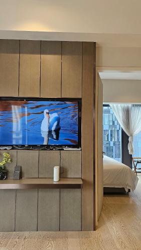 a bedroom with a flat screen tv on a wall at Star Residence Pool View 2br Unit Floor 8 in Kuala Lumpur