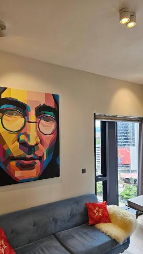 a painting on the wall of a living room with a couch at Star Residence Pool View 2br Unit Floor 8 in Kuala Lumpur