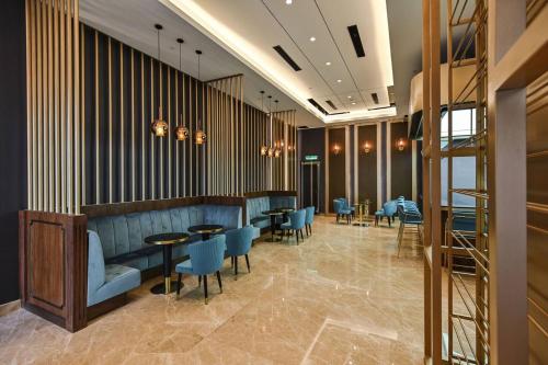 a restaurant with blue chairs and tables in a lobby at Star Residence Pool View 2br Unit Floor 8 in Kuala Lumpur
