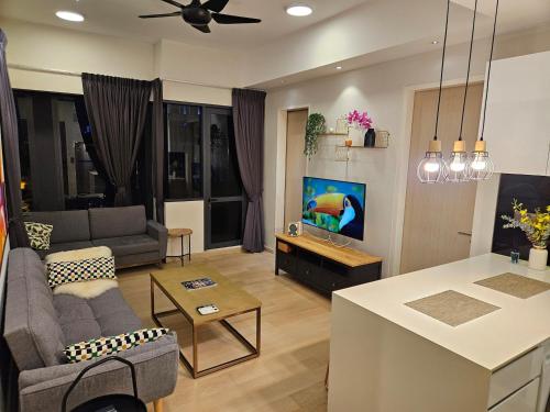 a kitchen and living room with a couch and a table at Star Residence 2br Unit Floor 46 in Kuala Lumpur
