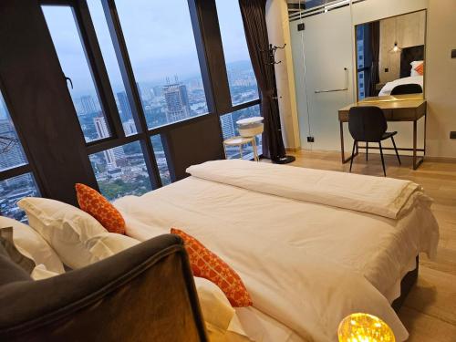 a hotel room with a large bed and a desk at Star Residence 2br Unit Floor 46 in Kuala Lumpur