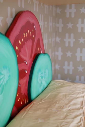 a painting of two mushrooms on a bed at Hesehotelli Turku Linja-autoasema in Turku