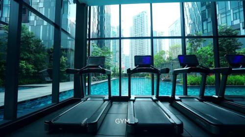 a gym with a view of a swimming pool at Star Residence 2br Unit Floor 46 in Kuala Lumpur