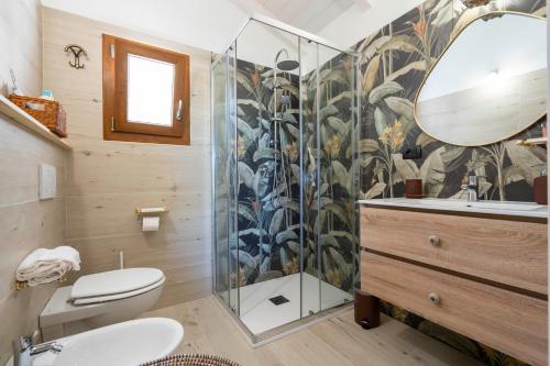 a bathroom with a shower and a toilet and a sink at Domus de Rocas Holiday House in Porto Rotondo