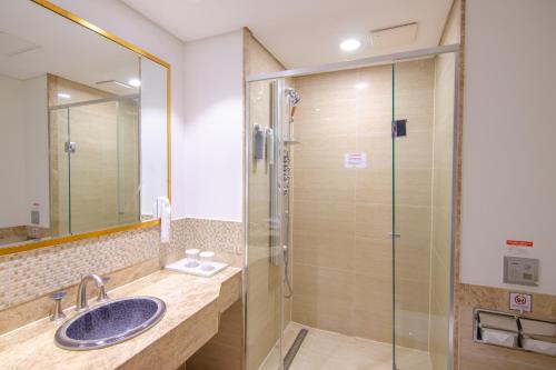 a bathroom with a sink and a shower at Centum Convention Hotel In Centum in Busan