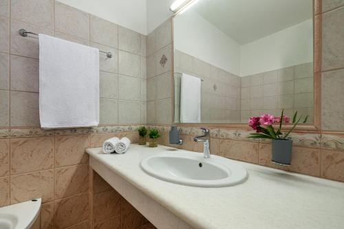 a bathroom with a sink and a mirror at Villa Mariani II - in Lothiarika, newly renovated June 2024, private pool, Lindos 10 min, beach 120m in Lardos