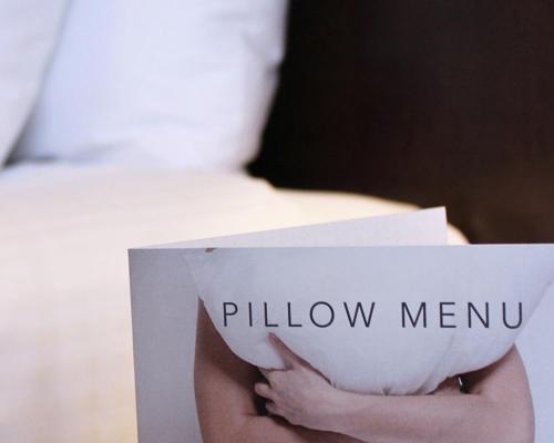 a person holding a sign that reads pillow meu at Hotel Grand Chancellor Adelaide in Adelaide
