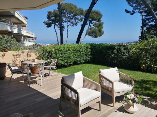 d'une terrasse avec des chaises et une table offrant une vue sur l'océan. dans l'établissement Appartement 3 pièces, à Antibes
