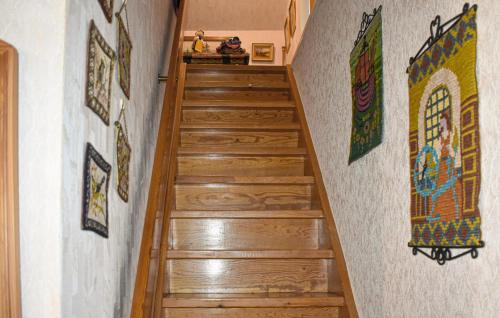 a stairway with wooden steps with mosaics on the wall at 4 Bedroom Stunning Home In Löderup in Löderup