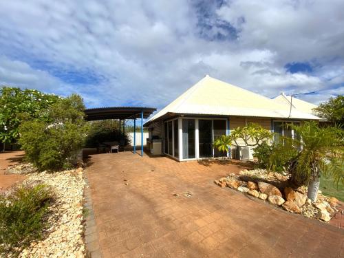 a house with a brick driveway in front of it at Osprey Holiday Village Unit 111 in Exmouth