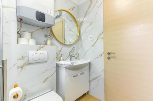 a bathroom with a sink and a mirror at Villa ARIJANA 2 in Slatine
