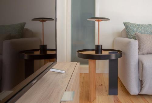 two side tables in a living room with a couch at GuestReady - Catorze de Outubro Houses 427 in Vila Nova de Gaia