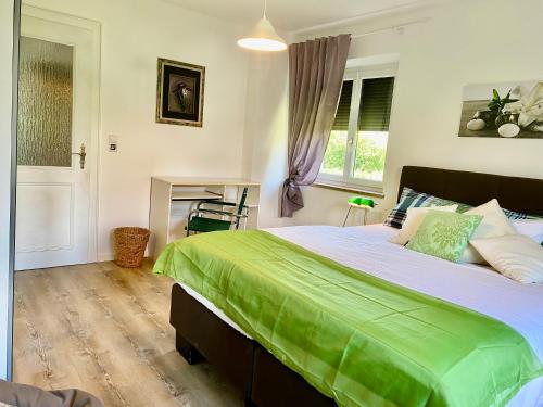 a bedroom with a large bed and a fireplace at Ferienwohnung Altes Zollhaus in Ering